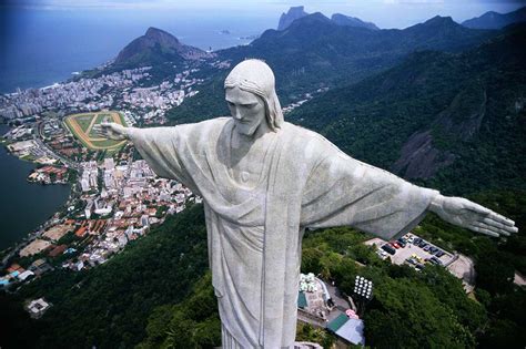 the statue of christ the redeemer looks over this city|Christ the Redeemer Statue .